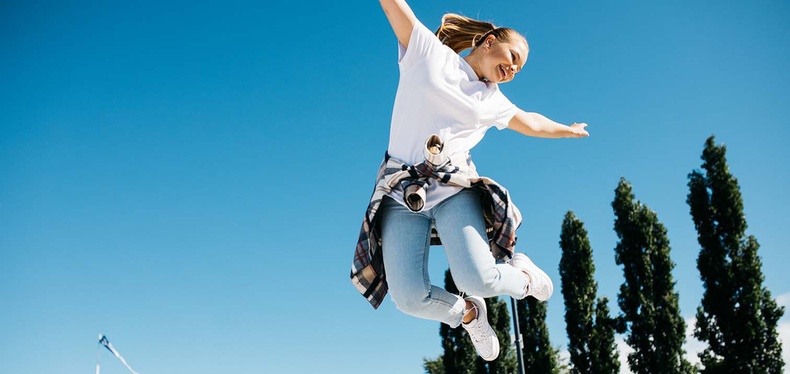 A young girls jumps in the air