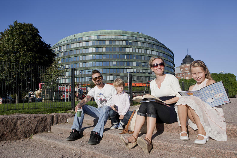 Parents and children sitting on stone steps